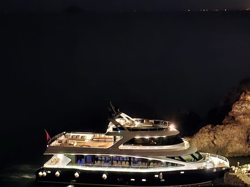 Private yacht lit up at night on the Bosphorus